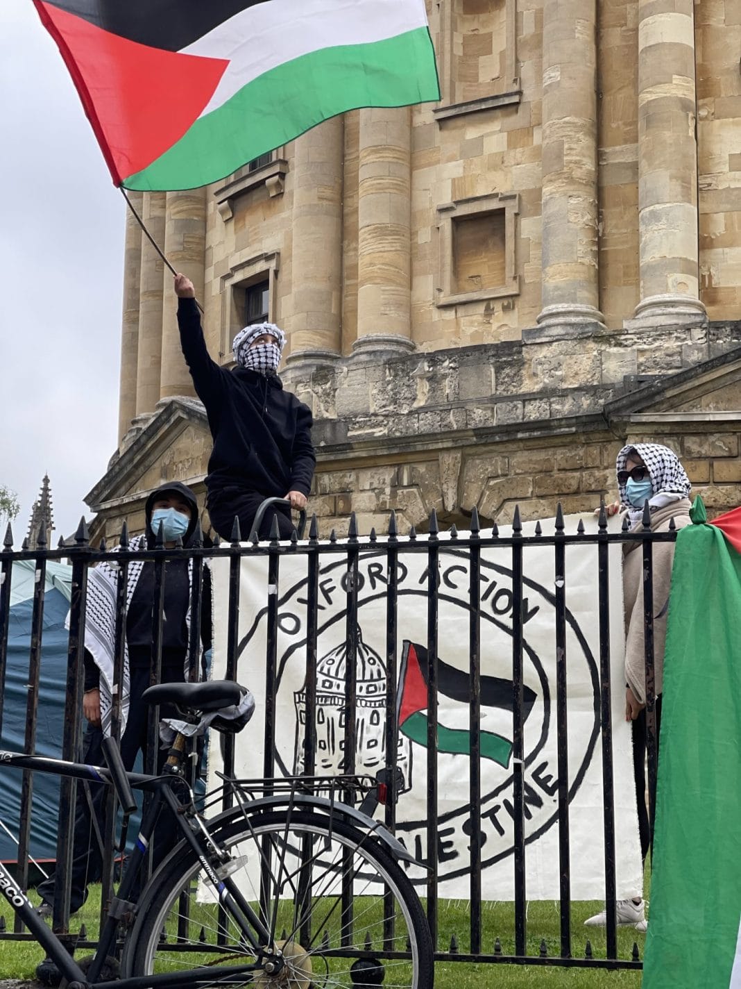 OA4P members waving a Palestinian flag in front of the Rad Cam.