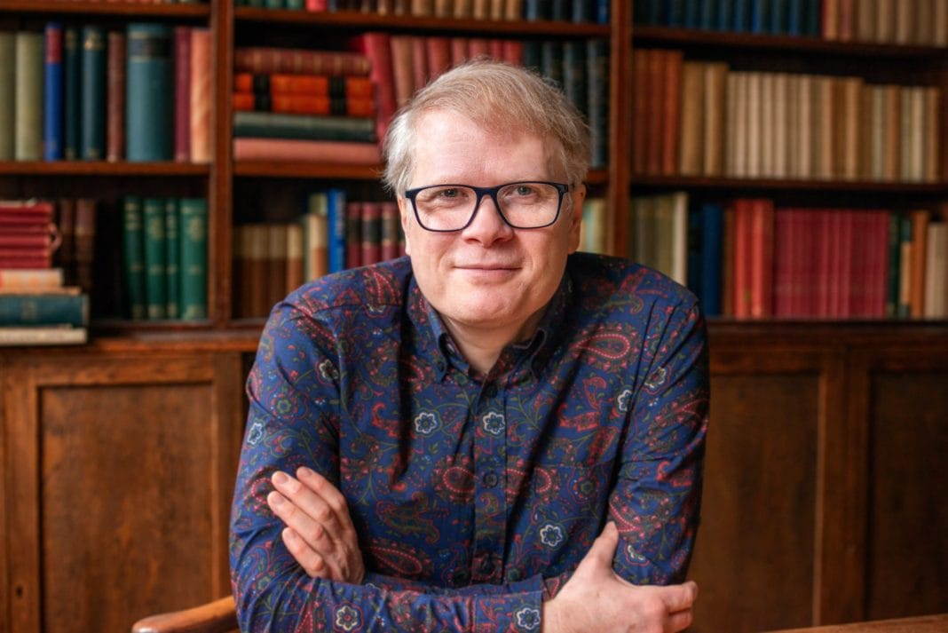 Adam Leslie with bookshelf